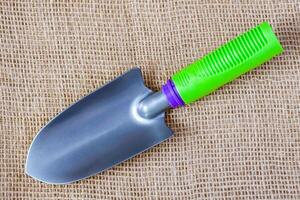 Small garden tool - trowel on the sackcloth surface photo
