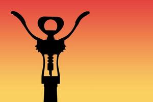 Abstract view of dark silhouette of a fragment a wine bottle with corkscrew a background of red orange gradient backlight photo