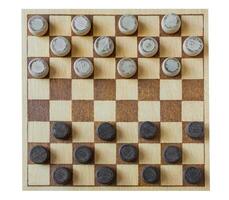 wooden checkerboard with checkers spaced on table isolated photo