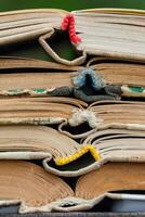 Closeup view of pile a opened books as background, texture photo