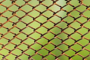 Metal rusty mesh on a neutral green background photo