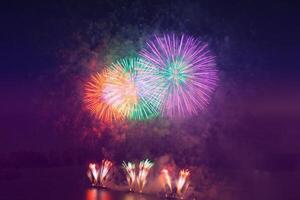 Colored fireworks on the deep blue sky background photo