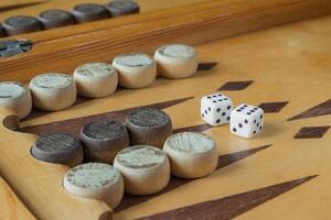 Wooden backgammon board with dice closeup photo