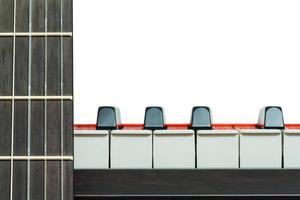 Piano keys and a fragment of neck of a guitar front view on a white background, closeup photo