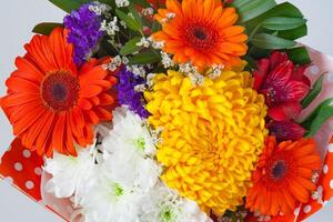 bouquet of flowers from red gerberas and chrysanthemums photo