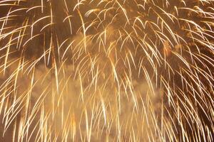 Golden sparks of festive fireworks as background photo