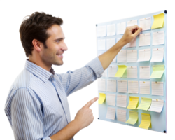 A young man arranges sticky notes on a board with a content smile, likely brainstorming or planning steps for a project png