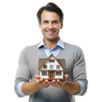Man in gray sweater and blue shirt cheerfully presenting a miniature house indoors with a clear, transparent backdrop png
