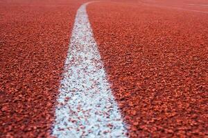 White line on a surface of running track as background photo
