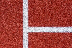 White lines on a red surface of running track texture, background, copy space photo