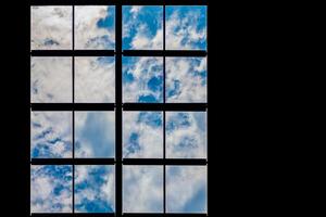 Lattice window overlooking the sky and clouds photo