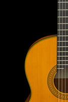 Fragment of classical guitar on a black background isolate, copyspace photo