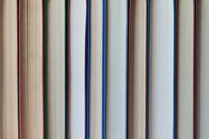 Books stand in a row background, texture photo