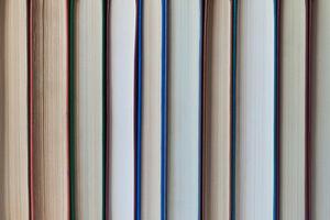 Books stand in a row background, texture photo