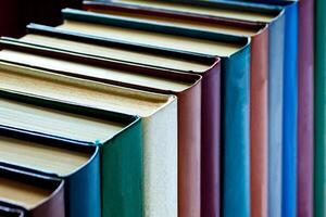 Books are arranged in a row on a black background photo