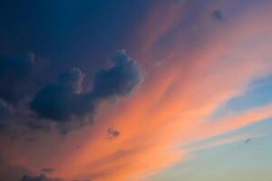 Dramatic view of clouds illuminated by the sun in the evening sky photo