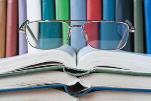 On open books lie glasses concept photo