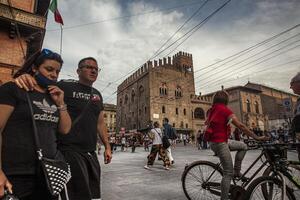 BOLOGNA ITALY 17 JUNE 2020 Palazzo Re Enzo a famous historic building in Bologna Italy with people walking in the square photo