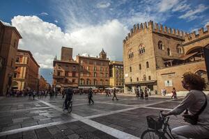 BOLOGNA ITALY 17 JUNE 2020 Palazzo Re Enzo a famous historic building in Bologna Italy with people walking in the square photo