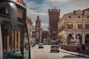FERRARA ITALY 29 JULY 2020 Evocative view of the road leading to the historic center of Ferrara with a view of the castle and life on the road photo