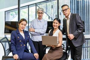 Group portrait of Asian business people team in formal suit from different ages that represent mix skill and knowledge concept photo