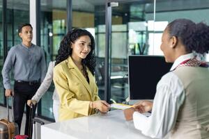 Passenger is getting boarding pass from the airline ground crew at departure gate into the airplane for flight check in before boarding into plane photo