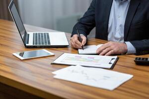 Businessman's hands close up, man at the table works with documents and paper contracts. photo