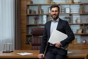 Portrait of successful and happy mature university teacher, man in business suit and academy director's office looking at camera and smiling. photo