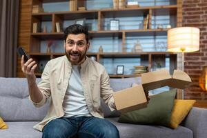 retrato de contento en línea comprador a hogar, maduro adulto hombre sonriente y mirando a cámara, participación producto caja y teléfono, contento acerca de rápido entrega desde en línea almacenar. foto