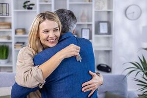 A husband and wife hug in a new apartment, the happy couple is happy with the buyers of the apartment. photo