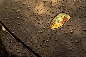 Masi Italy 7 june 2023 Close up photo of a black car featuring the iconic Porsche emblem and water droplets