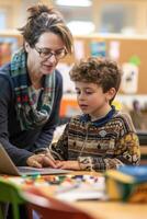 A focused image of a student using a speech-to-text device to complete an assignment, with a supportive teacher nearby, demonstrating accommodations for students with communication disabilities. photo