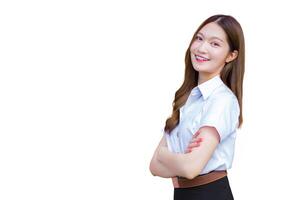 Portrait of an adult Thai student in university student uniform. Asian beautiful girl standing confidently with her arms crossed while isolated white background. photo