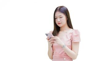 Young Asian professional business female with long hair is smiling while looking at the smartphone in her hand work from anywhere concept while isolated white background. photo