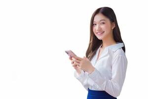 Young asian beautiful business female stands on flyover of skytrain in town while uses her smartphone to send messages to customers while isolated white background. photo