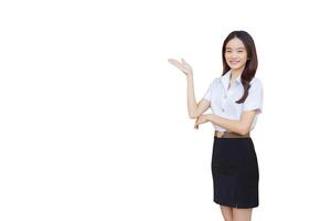 Portrait of an adult Thai student in university student uniform. Asian beautiful girl standing to present something confidently while isolated white background. photo