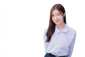 Beautiful high school Asian student girl in the school uniform stands and smiles happily with braces on her teeth while she confidently while she looks at the camera while isolated white background. photo