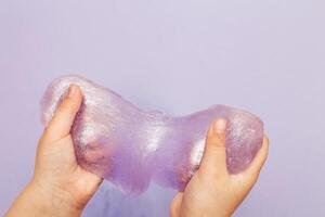 Making slime at home. child stretching colorful slime. DIY concept. photo