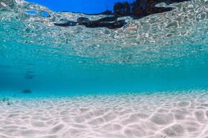 Tropical blue ocean water with sandy bottom underwater photo