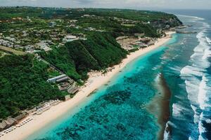 Aerial view of holiday beach with turquoise ocean and waves in Bali photo