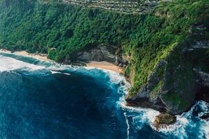 Scenic landscape with coastline and blue ocean with waves in Indonesia. Aerial view. photo