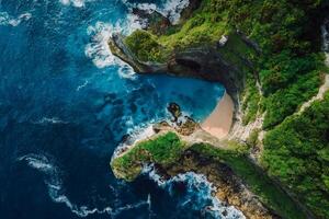 Scenic rocks, beach with blue ocean in Bali. Aerial view. photo