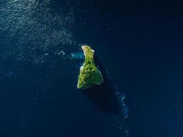 Alone scenic rock in ocean near Nusa Penida island. Aerial view photo