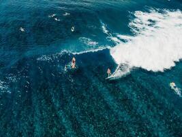 Aerial view with surfer on wave. Perfect waves with surfers in tropical ocean photo