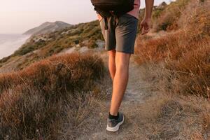 Legs of man walk outdoor with evening sunlight. photo