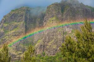 Colorful rainbow with rain and Le Morn brabant mountain photo
