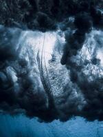 Barrel wave crash with vortex underwater in crystal ocean. Stormy water texture photo