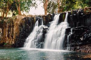 Rochester Falls in Mauritius. Cascade waterfall and beautiful black stone photo