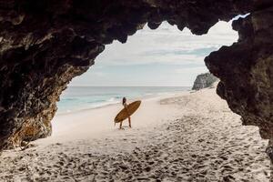 Surf girl with surfboard on tropical beach. Woman in sexy bikini with board photo