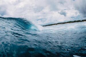 Big ocean blue wave. Breaking barrel wave photo